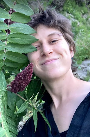 Ruth next to a Staghorn Sumac in summertime by the Connecticut River.